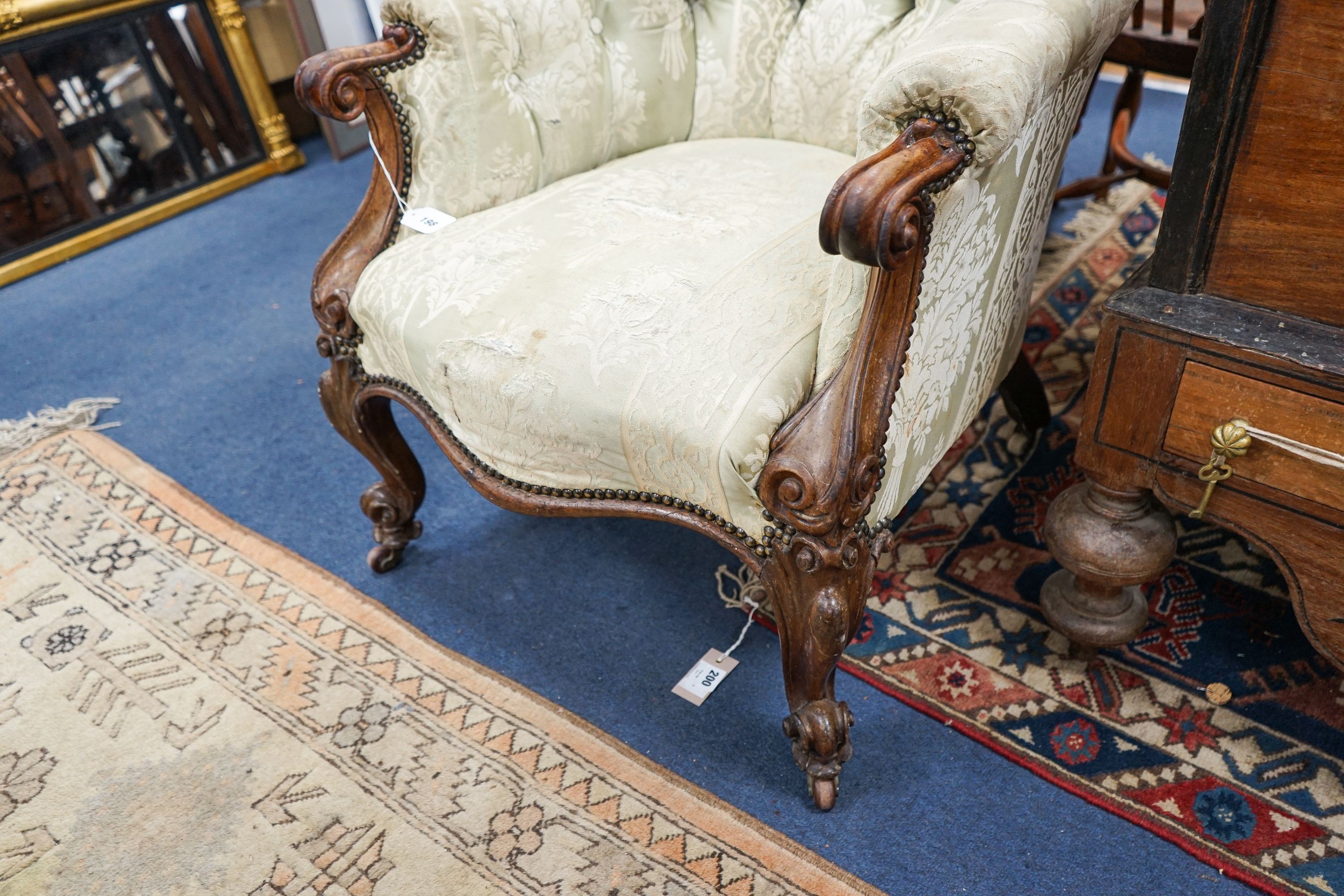 A Victorian rosewood upholstered spoon back armchair